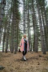 Fototapeta premium Beautiful asian woman relaxing in the middle of a pine forest.