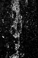 water jet with splashes and highlights on a black background