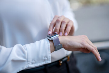 Close up picture of a woman touching a smartwatch
