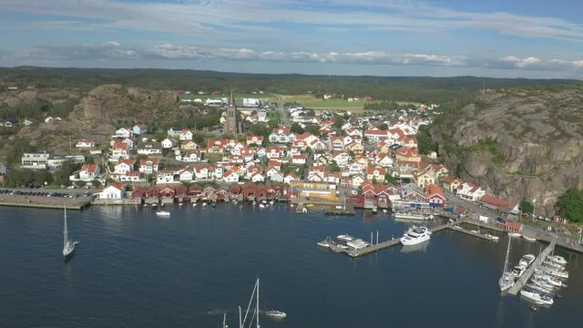 Aerial flying backward revealing coastal town Fjallbacka in Bohuslan, Sweden