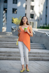 Smiling woman holding a coffee cup looking beautiful