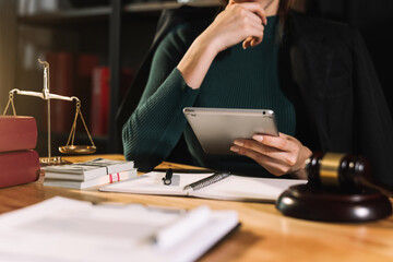 justice and law concept.Male judge in a courtroom  the gavel, working with smart phone and laptop...