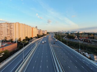 Aerial view panoramic landscape of Moscow city at sunrise. Multi-level intersection on an expressway in the city in the rays of the golden sun. Drone shot