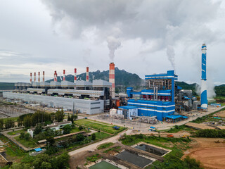 Lampang, Thailand - August 16, 2020: Mae Moh Coal power plant with steam pouring out of the stack.
