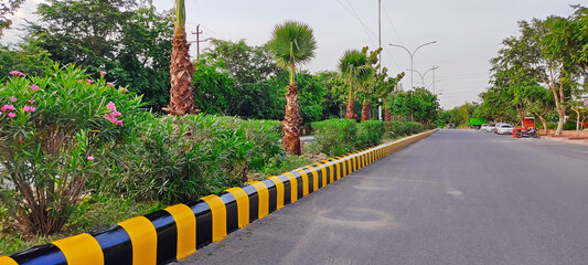 Beautiful City Road. Painted Divider with Lush Green Surrounding