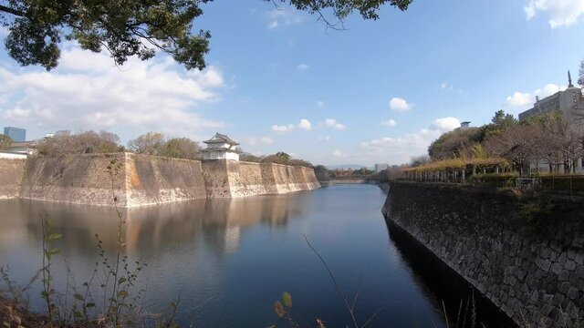 Time lapse of Japanese moat with blue Skys overhead