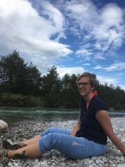 young woman sitting on a rock