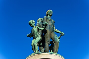 Fototapeta na wymiar Bronze statue with green patina, resemblance of women and children dancing naked.