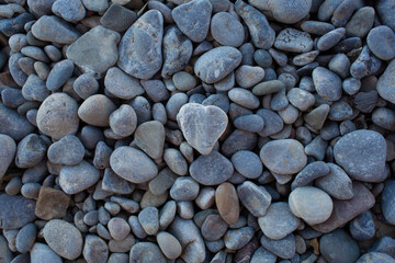 small grey pebbles on the beach near the sea