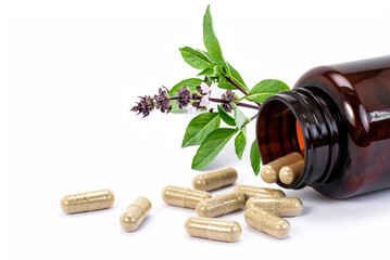 Herbal medicine pill capsule with basil leaf 