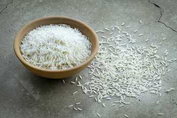 White basmati rice in clay bowl on a concrete worktop