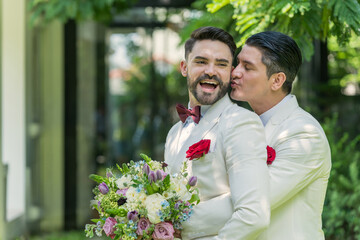 Newlywed gay couple hugging and kissing on wedding celebration, Portrait of men lovers on their ceremony. Concept of LGBTQ+, Same sex marriage and gender equality. 
