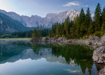 Naklejka na ściany i meble Panorama of an alpine lake on a beautiful sunny morning