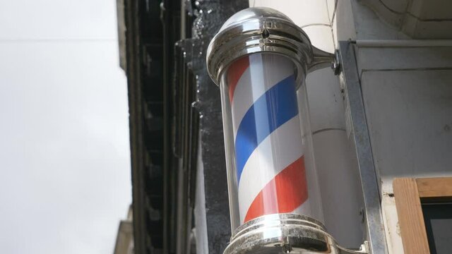 A barber pole rotating on a wall.