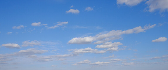 Blue spring sky with white clouds. Beautiful background.