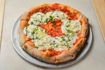 Fresh italian classic original Pepperoni Pizza served on wooden table. Italian cuisine.