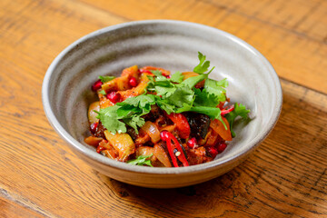 Georgian vegetable and meat salad with onion, basil, tomato, parsley and pepper.