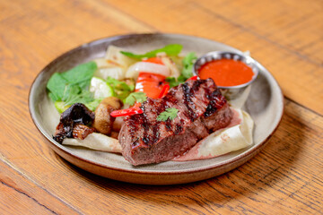 Georgian cuisine concept. Grilled meat with vegetables and sauce.