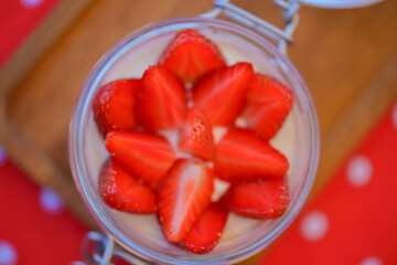 Dessert panna cotta with fresh strawberries served in a glass, selective focus. Delicious fruit...