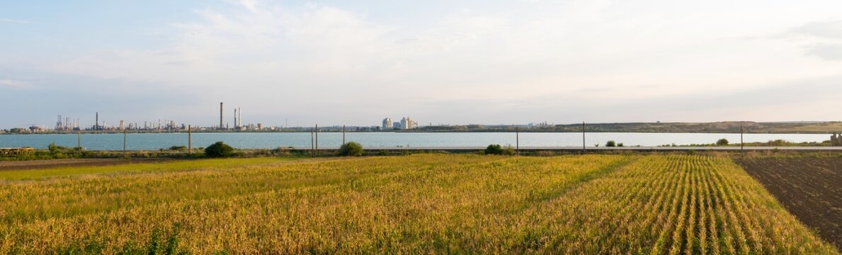 Constanta, Romania - August 16, 2019: Panoramic view of Lake Corbu with Navodari Petromidia Refinery in the background.