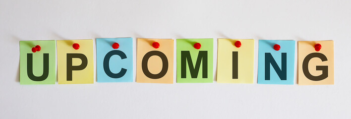 UPCOMING phrase is written on multi-colored stickers, on the white background. Business concept, strategy, plan