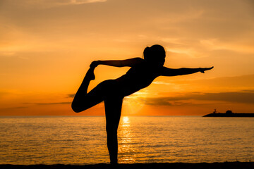 Silhouette woman make practice yoga and meditation for healthy with twilight sky background