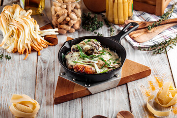 Baked chicken in creamy sauce with green onions