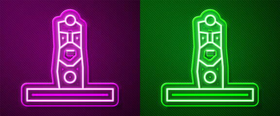 Glowing neon line Slavic pagan idol icon isolated on purple and green background. Antique ritual wooden idol. Vector.