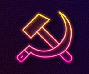 Glowing neon line Hammer and sickle USSR icon isolated on black background. Symbol Soviet Union. Vector.