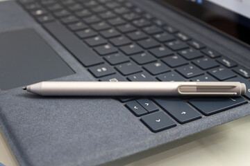 Closeup shot of a pen on a laptop keyword - the concept of business