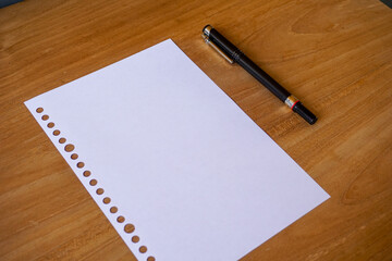 blank paper, ballpoint for mockup concept on wooden board. finance, education background