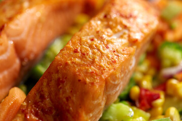 food cooking, eating and culinary concept - close up of baked salmon fish with vegetables