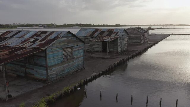 Three old houses in the salt mine of Bani, Dominican Republic, drone scene shot