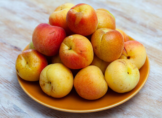Fresh juicy apricots on wooden background, harvest season