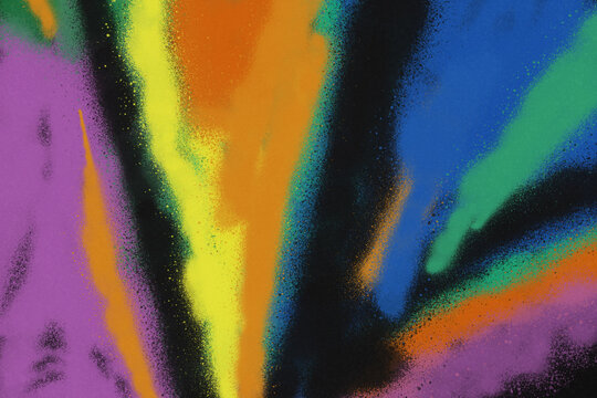 Colorful spray paint ink texture. Graffiti painting on the wall. Street art and vandalism. Digitally airbrushed paper background.
