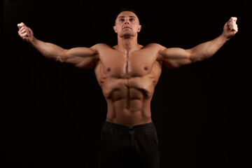 Fototapeta premium Muscular man stretching his arms out