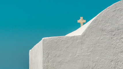 Fototapeta na wymiar Greek Orthodox Church on Mykonos Island against Teal Sky. Architecture Photography. Whitewashed Wall. Minimal Aesthetics.