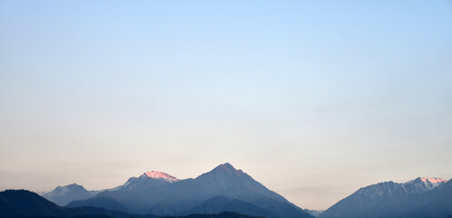 Fototapeta na wymiar Blue mountains silhouettes in the Asia, Kazakhstan in the evening.