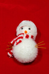 red christmas background with toy snow man.and space to add text