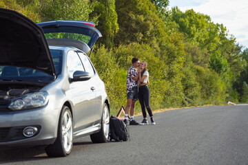 Boy placing triangle on fault signaling car