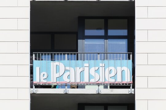 Odense, Denmark - April 9, 2017: Le parisien advertising on a building. Le Parisien is a French daily newspaper covering both international and national news