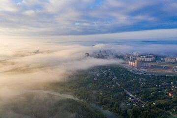 Thick fog spreads over the city of Minsk! In the distance you can see high-rise buildings and a construction crane! The river and the park.