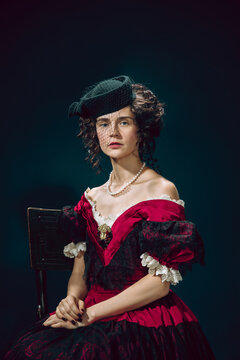 Love tragic. Young woman as Anna Karenina isolated on dark blue background. Retro style, comparison of eras concept. Beautiful female model like literature character, great, old-fashioned.
