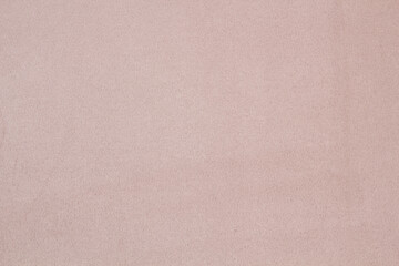 Ocher matte background of suede fabric, closeup. Velvet texture of seamless  leather.