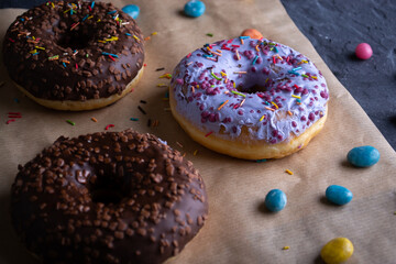 Donuts on a wooden board on a blue concrete background