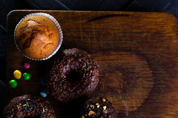 Donuts on a wooden board on a blue concrete background