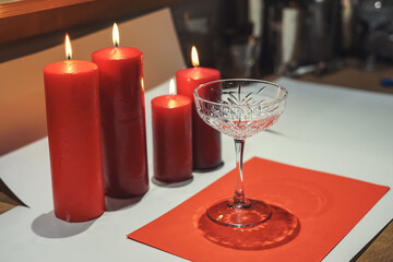 Red candles and glasses. table setting