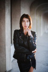 Brunette girl walking in the evening city on a summer afternoon