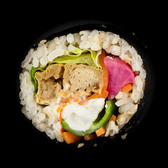 Top view Korean food shot traditional kimbap made of mayonnaise sauce,  tofu, chili carrot, lettuce, purple radish and rice isolated on a black background. Vegan asian food.
