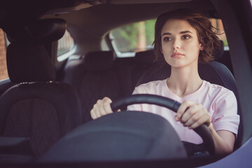 Photo of serious taxi driver girl ride drive car traffic town hurry passenger order hold steering wheel wear summer t-shirt outfit